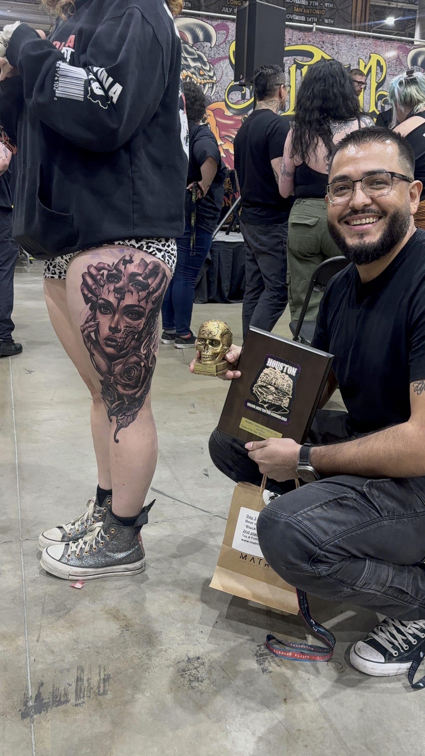 Happy Tattoo Artist displays award